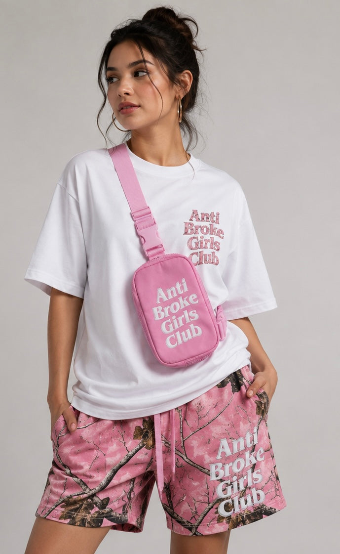 Person wearing 'Anti Broke Girls Club' branded clothing and crossbody bag on a plain background